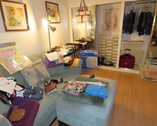 Den area, clothing, loveseat, stoarge boxes, sjoes, bags.