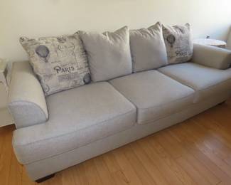 Lovely like new grey fabric queen size sleeper sofa with throw pillows.