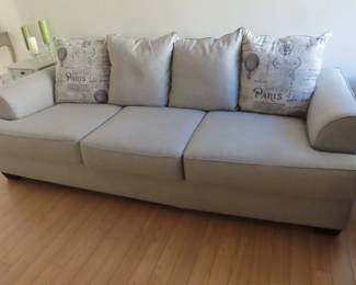 Lovely like new grey fabric queen size sleeper sofa with throw pillows.
