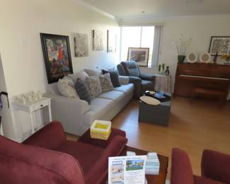 Living room furniture and piano.