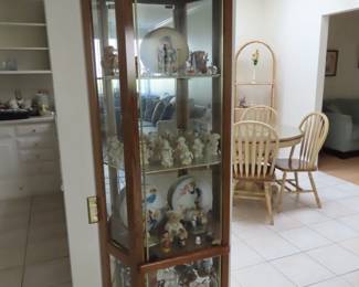 Narrow curio cabinet with mirrors.