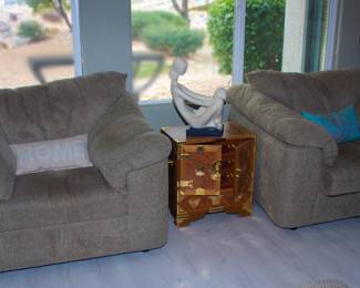 Upholstered plush chairs, ornate cabinet