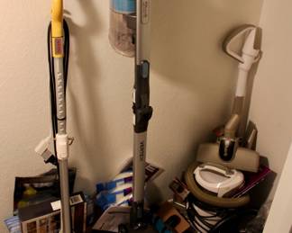 Various vacuums and cleaning supplies