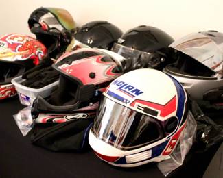 Lot of motorcycles helmets