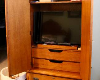 Large mirrored vintage storage cabinet with drawers and TV