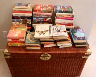 Collection of books and basket weaved chest