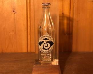 Encased 75th Commemorative Coca Cola Bottle
