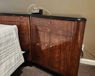 Available for Presale: B1 Brown & Black Drexel Heritage Furnishings Bedframe. Double platform bed, storage headboard with built in electrical power strip, side night stands with storage cabinet, draw, and pullout shelf. 9.6' W x 29" H x 6-12" D at various areas. Mattress is not included. Black lacquered top has chips on it. 
