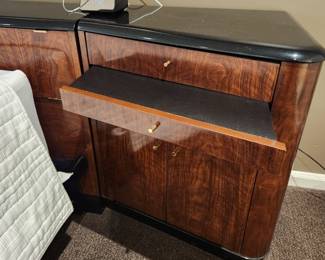 Available for Presale: B1 Brown & Black Drexel Heritage Furnishings Bedframe. Double platform bed, storage headboard with built in electrical power strip, side night stands with storage cabinet, draw, and pullout shelf. 9.6' W x 29" H x 6-12" D at various areas. Mattress is not included. Black lacquered top has chips on it. 