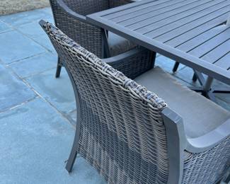 Available for Presale. O1- 4 Wicker Chairs & Metal Table with Umbrella. Tops of Chair backs have wear & tear. Slight hole on top of table where umbrella is. 42"D x 41"W x H 29". Chair Back 34"Hx W9" x D19". Seat 20"