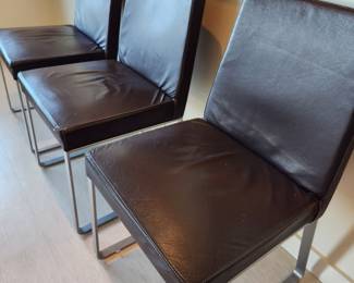 Available for Presale: C3- 6 Armless side chairs by Blueprint Furniture, Los Angeles, CA . Coffee leather, satin finish steel base. There are some very minor scratches on the chairs that could be. Leather could eliminate many of the minor scratches. Please inspect each photo carefully.  Back 34"H, Seat 19" H, W19" x D 17" 