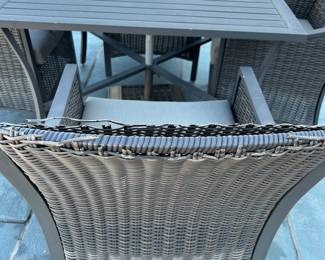 Available for Presale. O1- 4 Wicker Chairs & Metal Table with Umbrella. Tops of Chair backs have wear & tear. Slight hole on top of table where umbrella is. 42"D x 41"W x H 29". Chair Back 34"Hx W9" x D19". Seat 20"