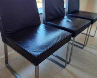 Available for Presale: C3- 6 Armless side chairs by Blueprint Furniture, Los Angeles, CA . Coffee leather, satin finish steel base. There are some very minor scratches on the chairs that could be. Leather could eliminate many of the minor scratches. Please inspect each photo carefully.  Back 34"H, Seat 19" H, W19" x D 17" 
 