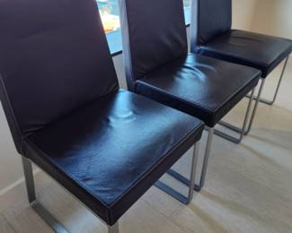 Available for Presale: C3- 6 Armless side chairs by Blueprint Furniture, Los Angeles, CA . Coffee leather, satin finish steel base. There are some very minor scratches on the chairs that could be. Leather could eliminate many of the minor scratches. Please inspect each photo carefully.  Back 34"H, Seat 19" H, W19" x D 17" 