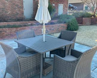 Available for Presale. O1- 4 Wicker Chairs & Metal Table with Umbrella. Tops of Chair backs have wear & tear. Slight hole on top of table where umbrella is. 42"D x 41"W x H 29". Chair Back 34"Hx W9" x D19". Seat 20"