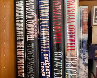 Group of books including The Last Precinct by Patricia Cornwell