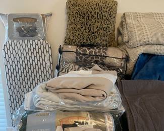 2 complete bedding sets, bed skirt, mattress cover, new ironing board.