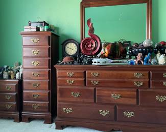 Wide chest of drawers with attached mirror.  All furniture pieces in this set are protected by custom glass covering.  Zoom in to see decor for sale