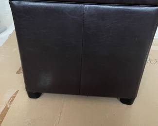 Leather-like bench with lid that turns into a tray when turned upside down.