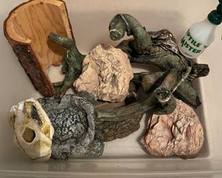Reptile habitat props - water bowls, "rock" basking platforms, giant "wood" climbing branch, fake scull, wood bark "bridge/hiding spot", large lamp cover for terrerrium (not shown), misting water bottle.