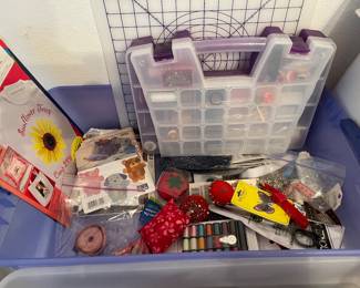 Assorted sewing notions, sewing supply sectioned box, graphed cutting board, iron on designs.
