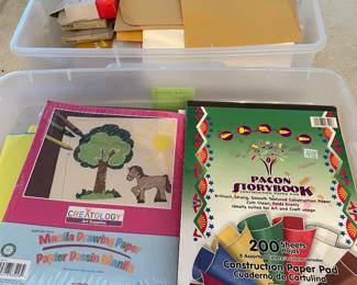 Colorful construction paper, bright color papers, tub full of various sized envelope, legal, standard, resume-type envelopes, manilla envelopes.