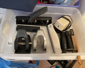 Several hole punchers, electric pencil sharpener, 3 staplers.