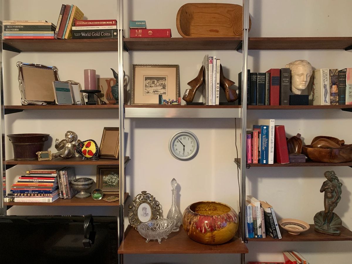 This is a house full of treasures gathered in travels around the world: hand carved wooden bowls, statuary, gilded frames, and ceramic and glass vessels.