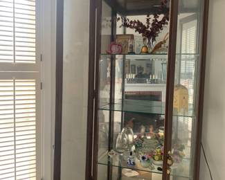 This glass fronted cabinet is tall and handsome, filled with small treasures for you to explore, cut crystal and fired ceramics.