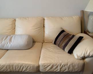 The warm white leather sofa is a standard length and width. Excellent condition.
