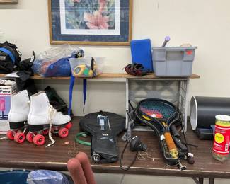 Roller skates tennis rackets baseball mits bats and balls 
