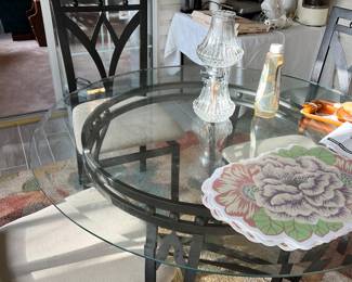 glass and black wrought iron table with 4 chairs, rug