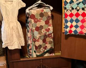 2nd bedroom - vintage armoire, several nice quilts, child’s dress