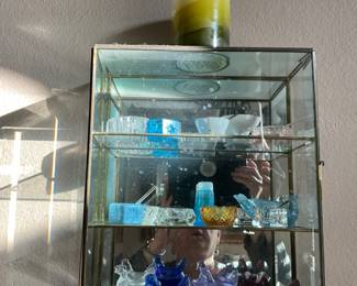 Small collectibles in glass cabinet 