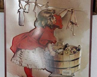 Vintage metal sign with little girl drying clothes 