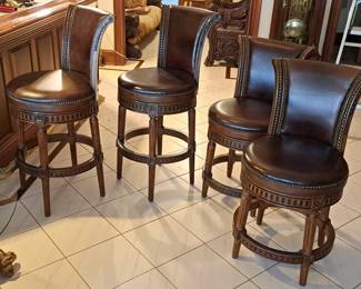 Set four leather covered bar chairs.