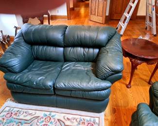 Leather look loveseat and end table.