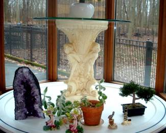 Faux bonsai bush on round table with marble base and misc. collectibles including large geode.