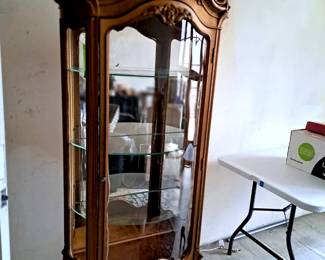 Carved, decorated vintage curio cabinet.