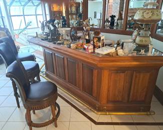 three of four bar chairs and collectibles on bar.