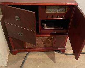 Radio/record cabinet. Radio works. Maybe you can get the record player to work! 