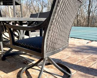 SOLD—Side view of swivel chair (1 of 2) included with Agio outdoor table.