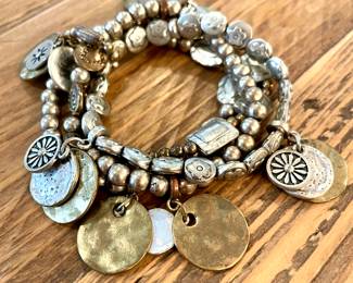 $50. Mixed metal elastic stacked bracelet with multiple charms. 