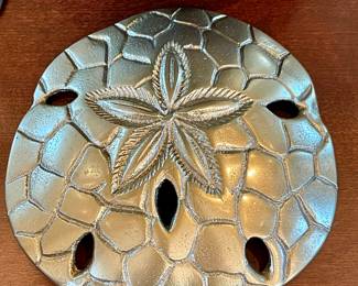 SOLD — close up of sand dollar decor.