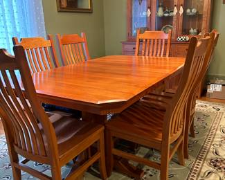 Amish handcrafted solid cherry dining table with 2 self storing leaves and 6 chairs and china cabinet. Purchased at Roses and Oak Ranch Wine Country Furniture 