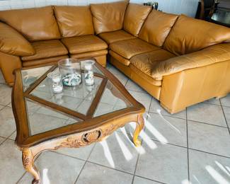 Faux leather sectional sofa and wood banded glass-topped coffee table with cabriole legs