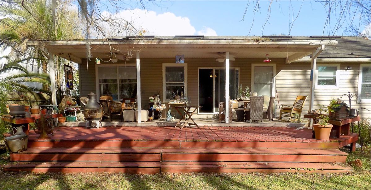 Outside Deck filled with outdoor furniture, lanterns, seashells, planters, etc.
