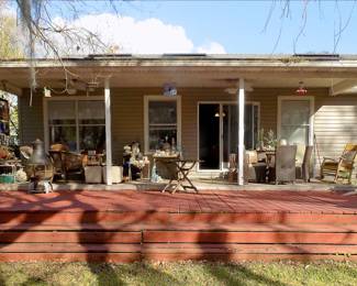 Outside Deck filled with outdoor furniture, lanterns, seashells, planters, etc.