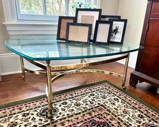 Hollywood Regency beveled glass and brass footed, coffee table