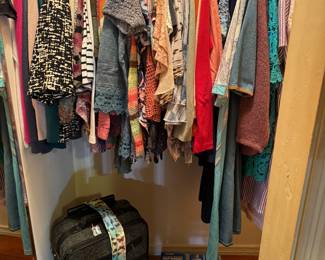 Women’s clothing, size, medium, and large, size 12 to 14. Suitcases and duffel bags.  